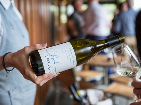 pouring Braemore Semillon into a glass at Thomas Wines Winery