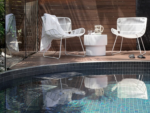 a close-up shot of the pool with two lounge chairs at The Lodge, Noosa Heads
