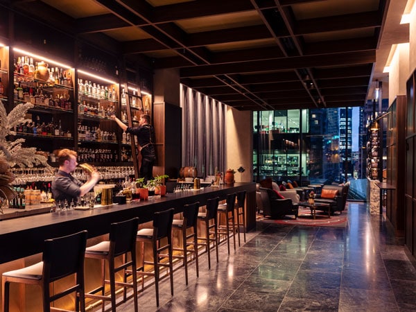 Bartender shakes cocktails at La Madonna Restaurant and Bar at Next Hotel in Melbourne