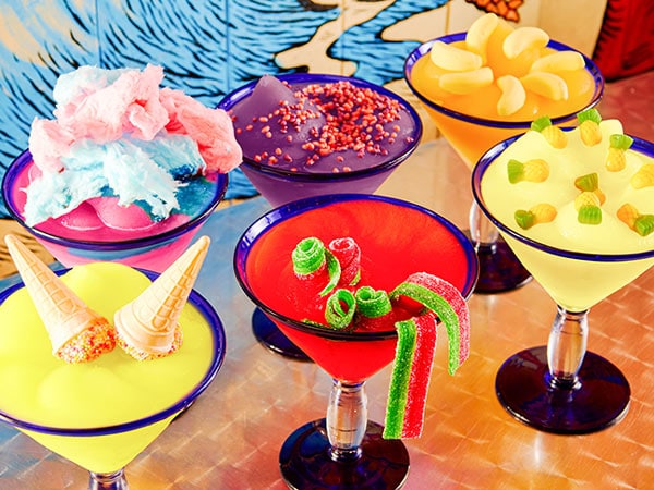 A photo of six colourful cocktails.