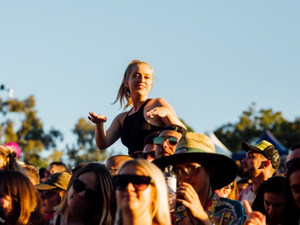 A girl on someone's shoulders.