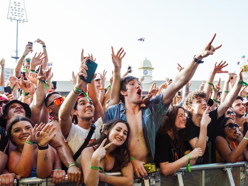 People dancing and singing at a festival.