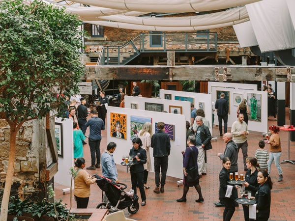 People walking in a gallery.