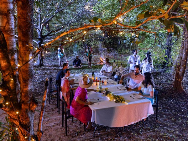 People sitting around a table outdoors.