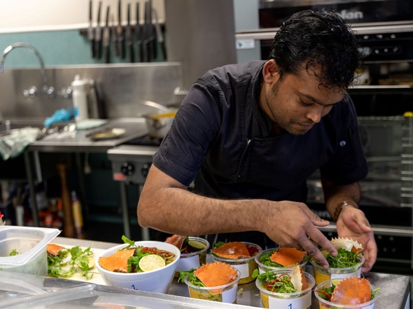 A man preparing food in a kitchen.