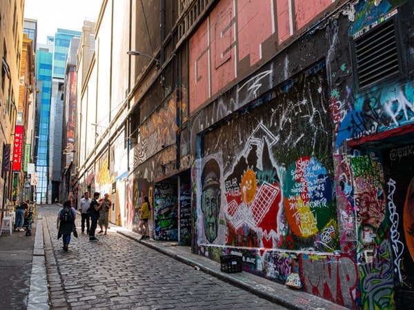 People walking past street-art-in Melbourne's Hosier Lane