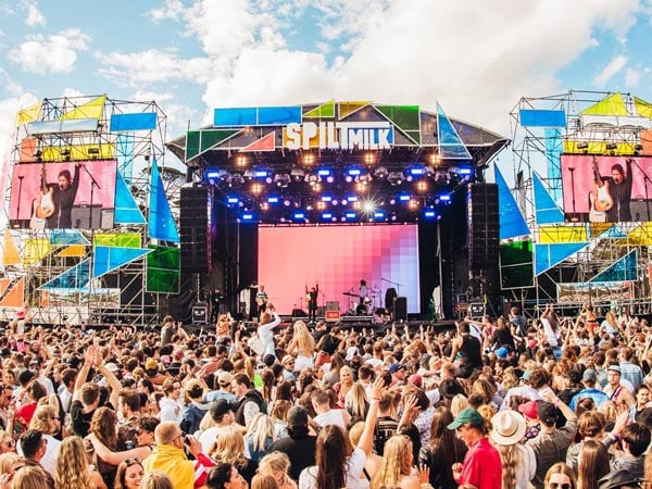 People singing and dancing at a festival.