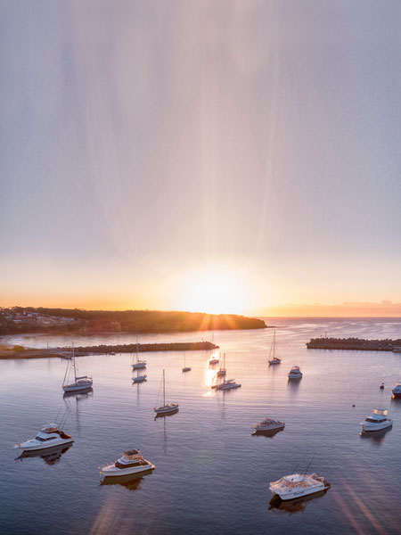 The sun rises over Ulladulla Harbour