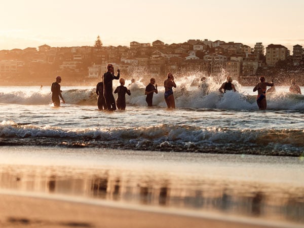 Swimmers heading into the water at Bondi Beach in Sydney