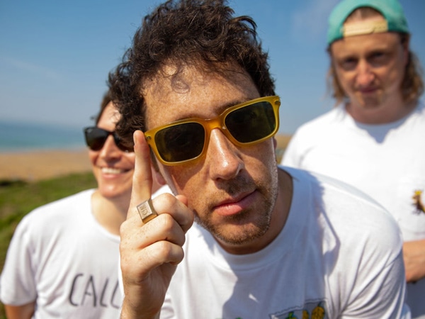 Three men on a beach.