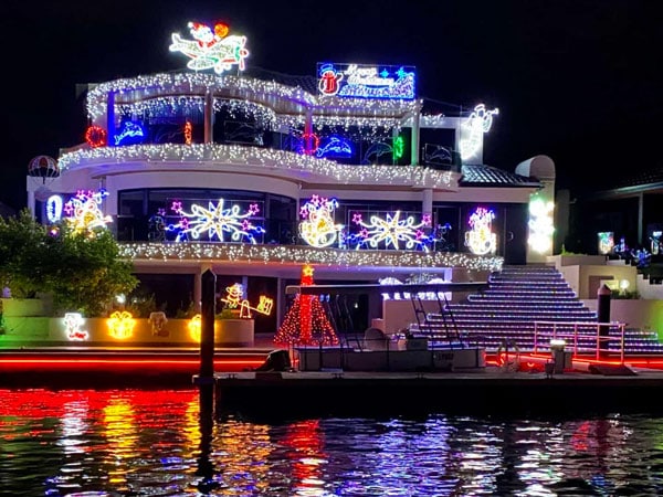 Christmas lights on a house near the water.