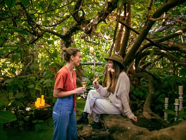 Two women drink wine at Gastronomo Enchanted Fig Tree on Kangaroo Island. 