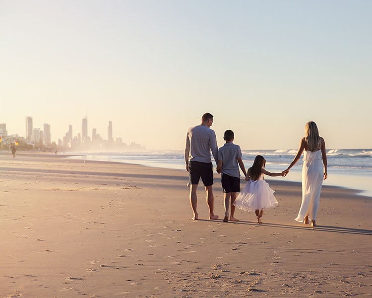 Family walking by the beach in The Gold Coast