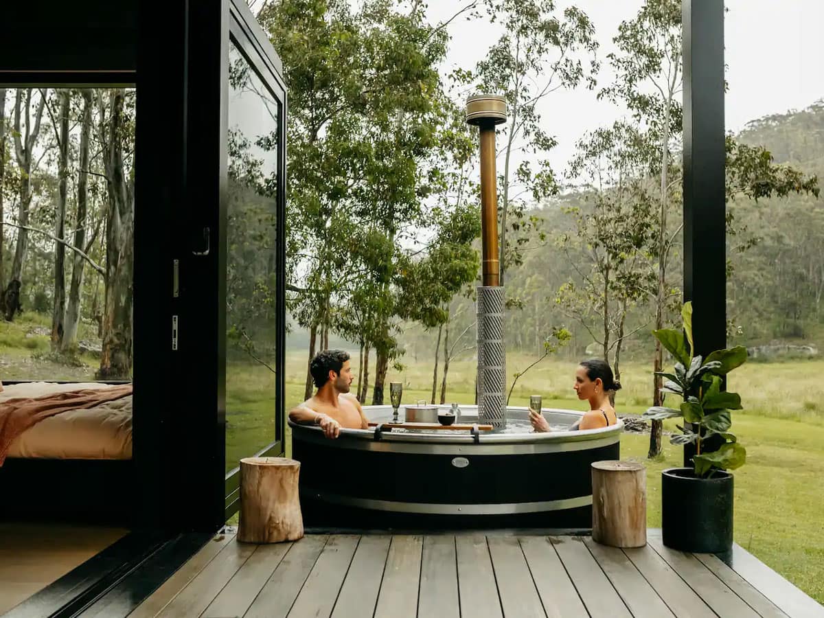 a couple relaxing in the outdoor tub at Billy’s Hideaway, Hunter valley