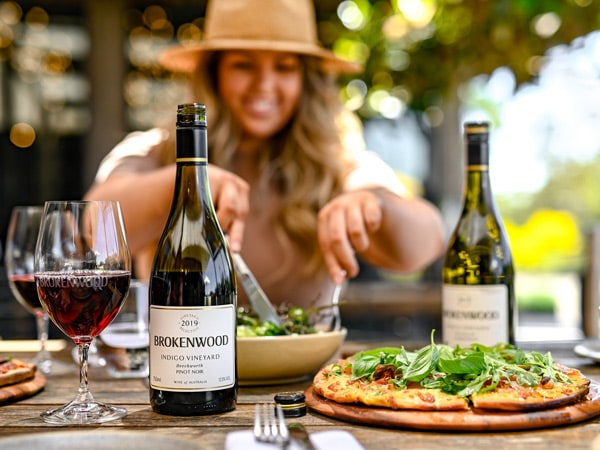 a woman eating at The Wood Restaurant at Brokenwood Wines