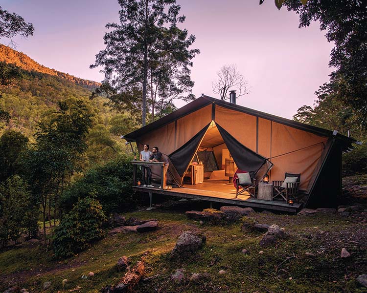 Couple outside the Nightfall glamping tent exterior