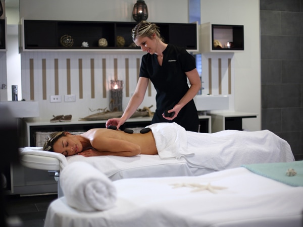 a massage therapist serving her client at Endota Spa Noosa