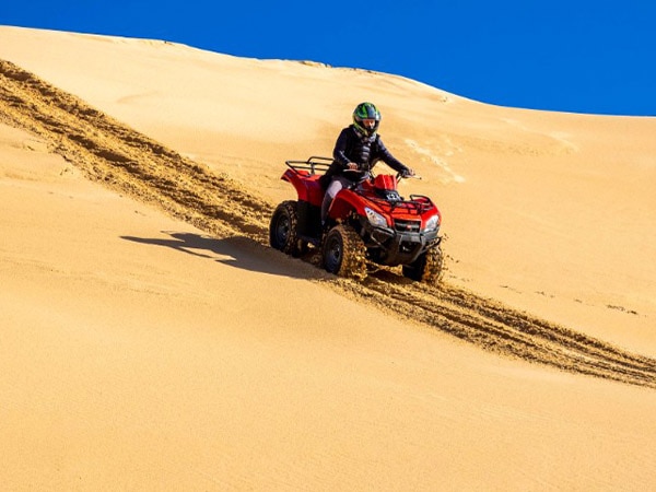 Man riding quadbike in the sand dunes, Sand Dune Adventures, Stockton, Australia