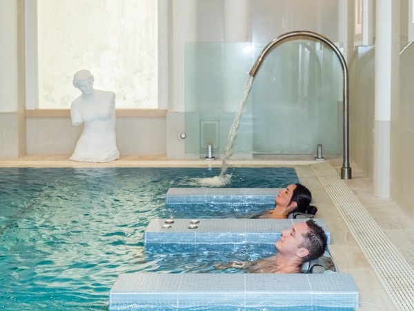 two people soaking in a massage pool at Noosa Springs Spa