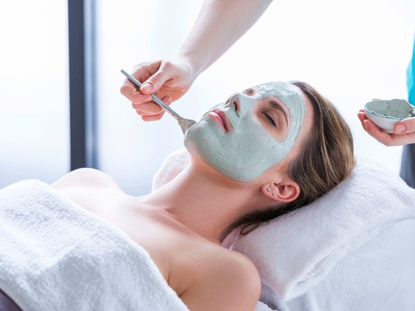 a woman getting a facial mask treatment at One Spa at RACV Noosa Resort