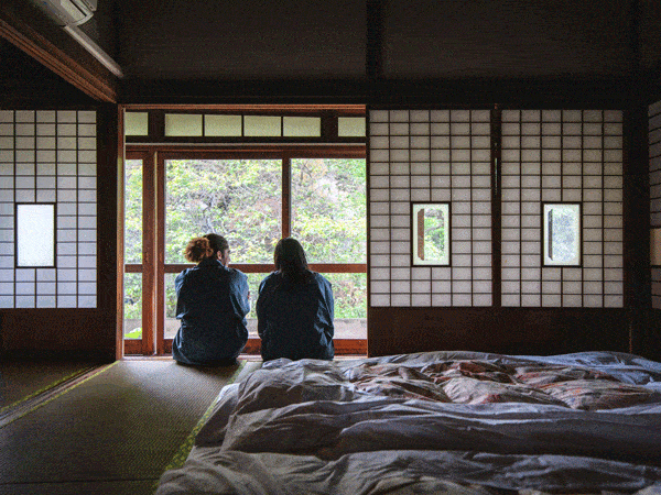 A couple sitting inside a traditional japanese ryokan