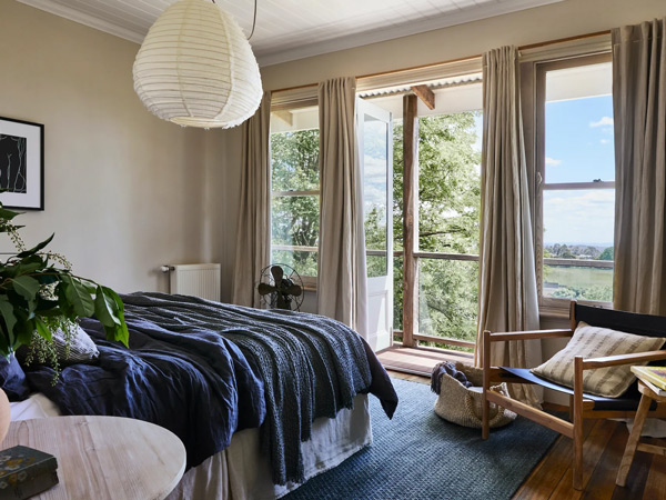 a bedroom facing sweeping views from the verandah