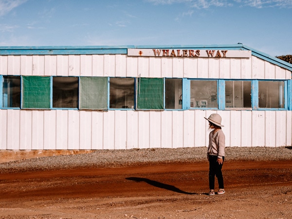 A girl stands out the front of a building in Whalers Way. (Image: Kristy Billing @gypsyandherwild)