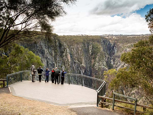 Family looking at the Wollomombi Falls, New England High Country, NSW, Australia