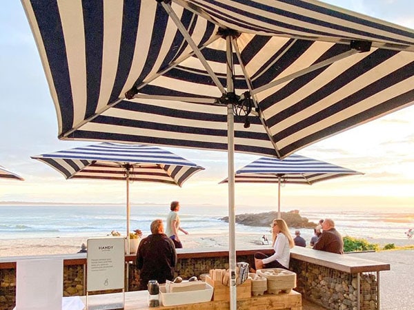 Beach under an umbrella, Salty Crew, Port Macquarie, NSW, Australia