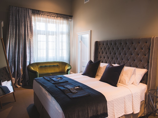 an elegant bedroom inside The Houston boutique hotel in Wagga Wagga