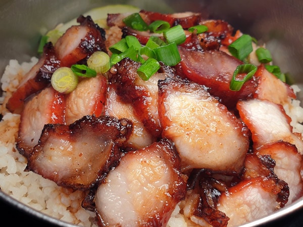 Delicious roast pork with white rice served in a take away food tray
