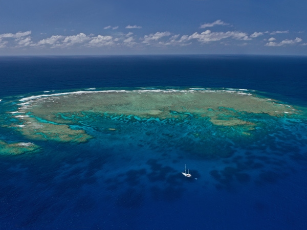 Aerial view of the MS Kiana moored off the Great Barrier Reef. (Image: Tourism and Events Queensland and Johnny Gaskell)