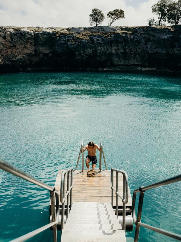 Man swimming in Little Blue Lake in Mount Gambier