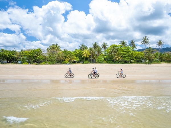 three people biking along Mission Beach