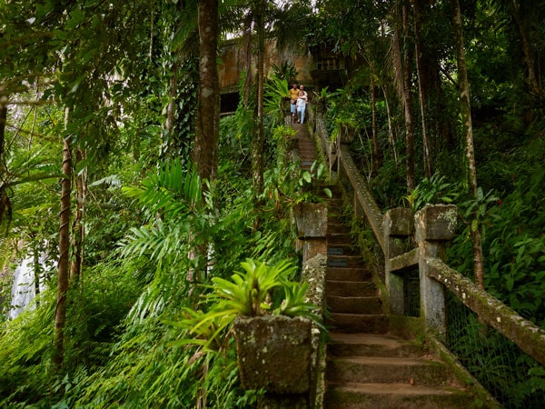 people going down an old staircase at Paronella Park