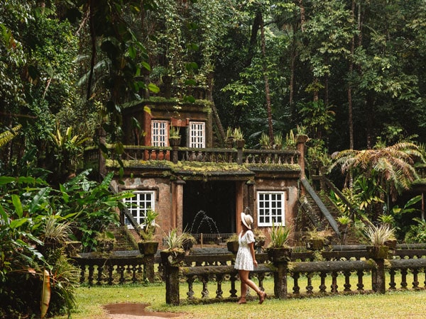 a woman exploring the castle at Paronella Park