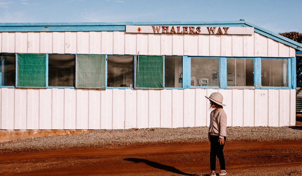 A girl stands out the front of a building in Whalers Way. (Image: Kristy Billing @gypsyandherwild)