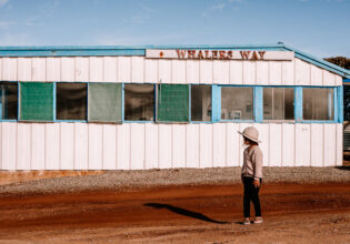 A girl stands out the front of a building in Whalers Way. (Image: Kristy Billing @gypsyandherwild)