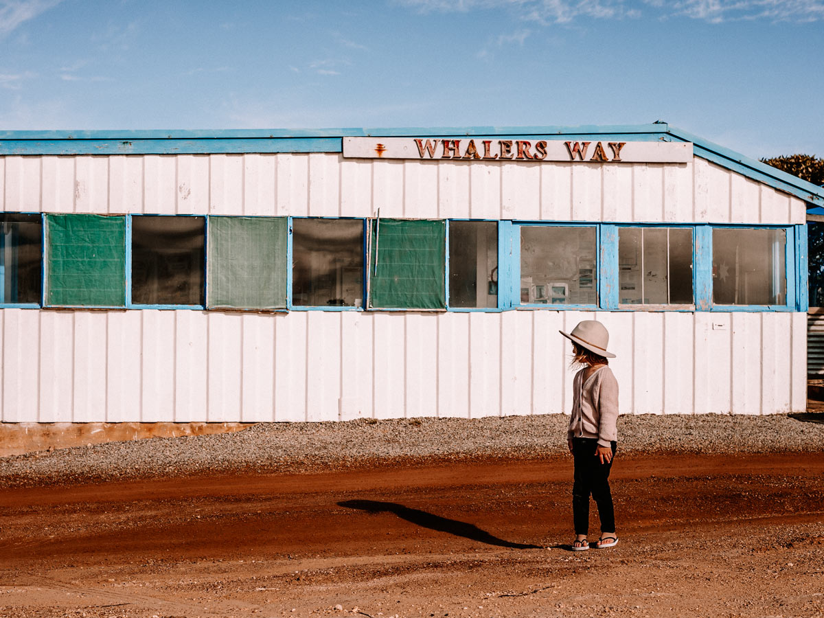 A girl stands out the front of a building in Whalers Way. (Image: Kristy Billing @gypsyandherwild)