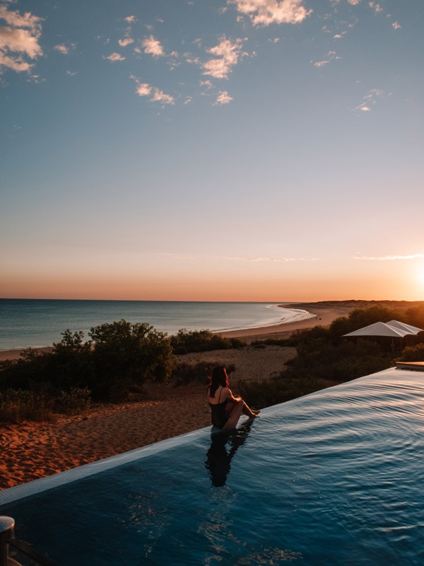 A woman relaxing at the pool at Eco Beach Resort. (Image: Tourism Western Australia)