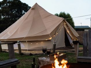 a glamping tent with bonfire at Pine Country Caravan Park in Mount Gambier