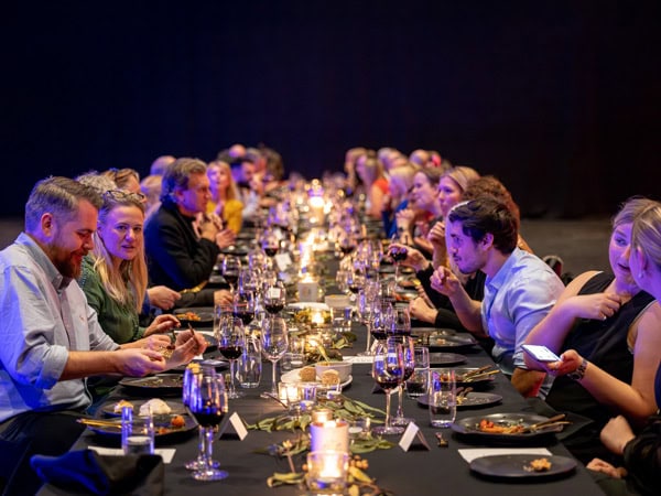 people sitting at a long table dinner during the Warakirri Dining Experience