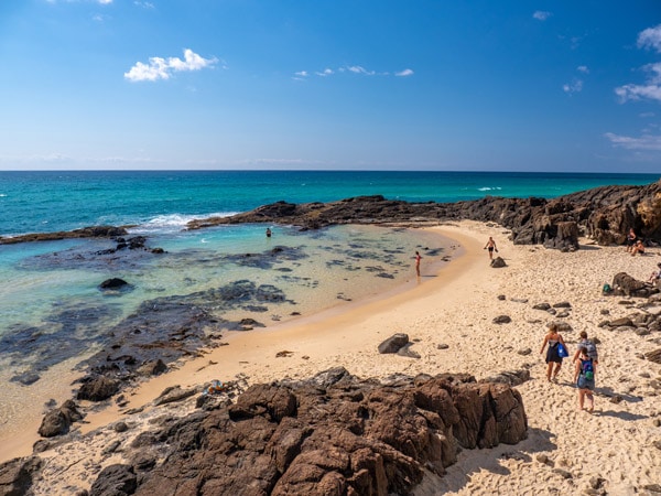 Looking over Champagne Pools on a sunny day. (Image: Tourism and Events Queensland)