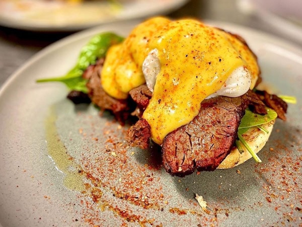 a plate of breakfast meal with brisket as the main ingredient at Cue & Crew