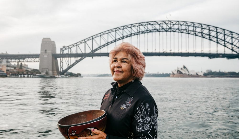 Margret Campbell standing in front of the Sydney Harbour Bridge. (Image: Destination NSW and Margret Campbell)