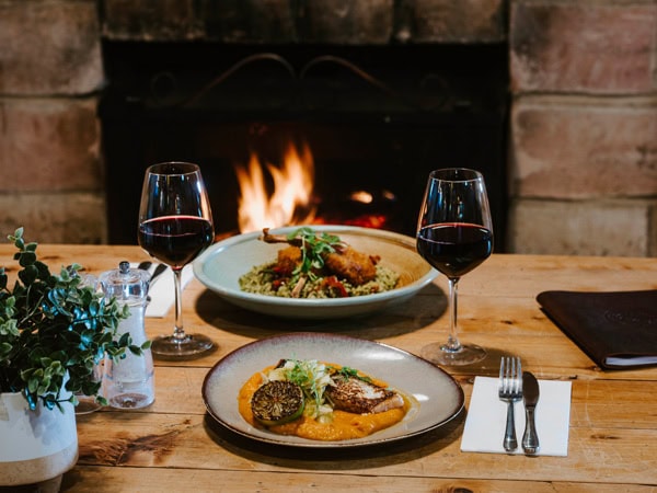 a dinner spread on the table near the fireplace at Kelly’s Irish Pub, Mudgee