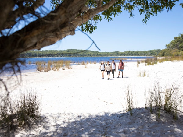 Group of people hiking on Lake Boomanjin. (Image: Tourism and Events Queensland)