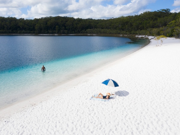 A shot of a couple enjoying Lake McKenzie (Image: Tourism and Events Queensland)