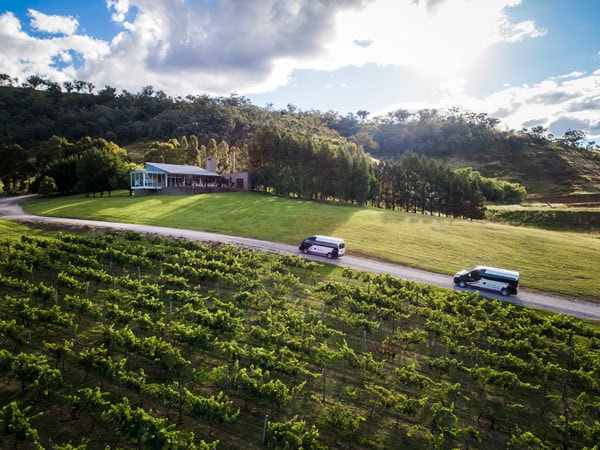 an aerial view of vehicles driving across the scenic vineyard landscape, Mudgee VIP Wine Tours