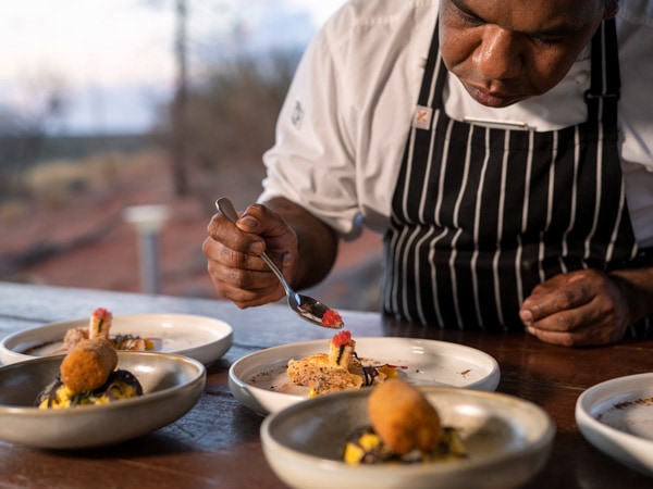 Tali Wiru chef plates up entree for guests